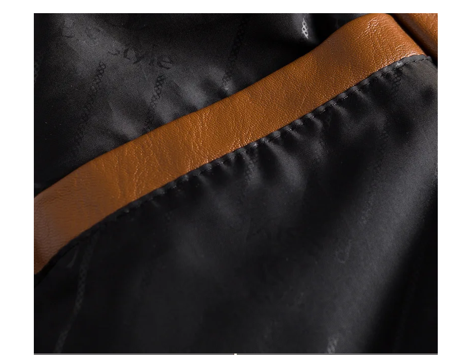 Close-up of a black bag with a brown leather strap
