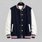 Navy and white varsity jacket with red and white accents on a hanger against a tiled wall.