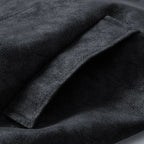 Close-up of dark gray fabric with a textured surface