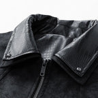 Close-up of a black leather jacket with crocodile texture collar on a white background