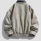 Light gray jacket with black leather collar on a light gray background