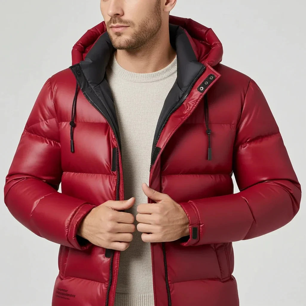 Man wearing a red puffer jacket with black accents on a light gray background