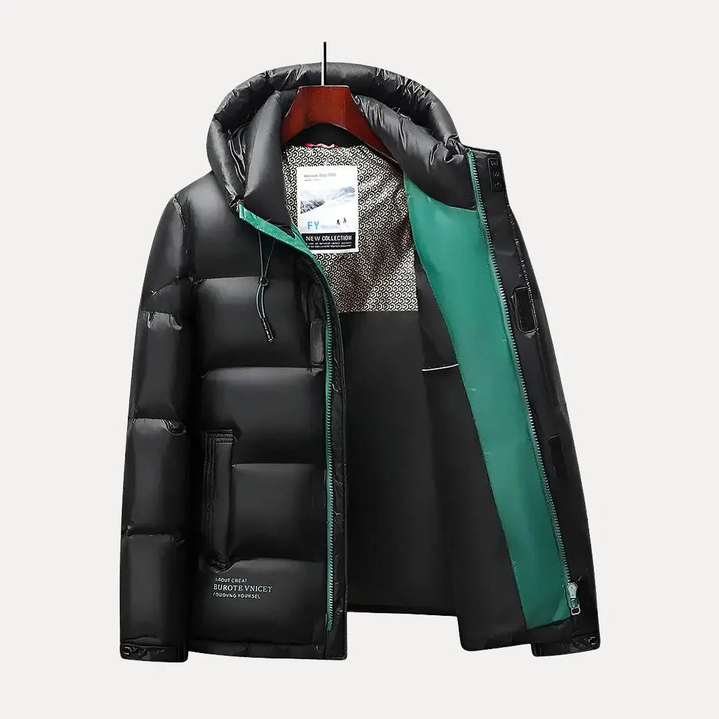 Black and green puffer jacket on a white background