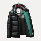 Black and green puffer jacket on a white background