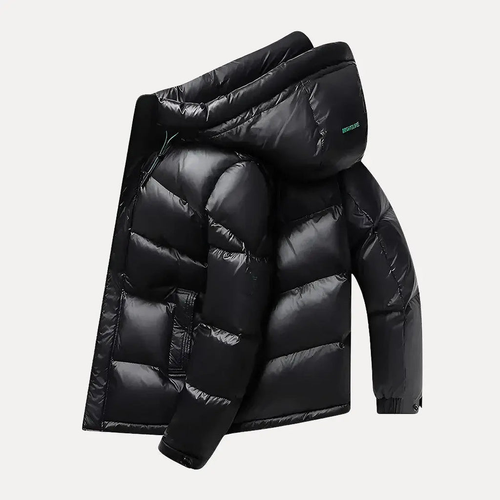 Black puffer jacket with a hood on a light gray background