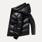 Black puffer jacket with a hood on a light gray background