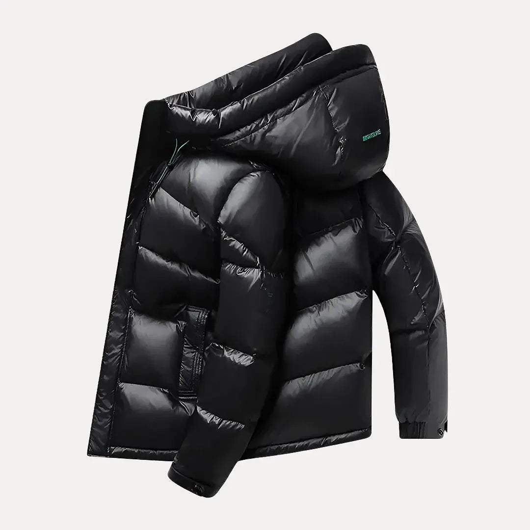 Black puffer jacket with a hood on a light gray background