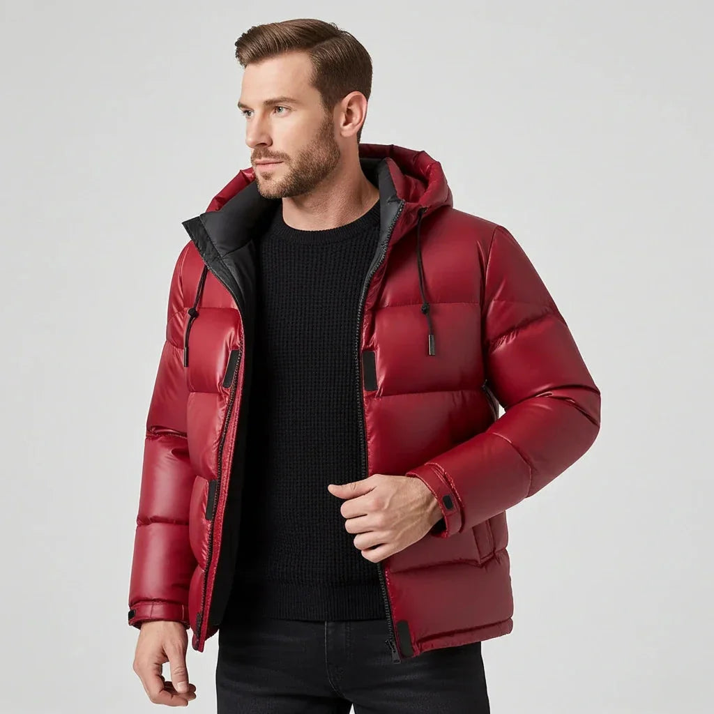 Man wearing a red puffer jacket on a light gray background