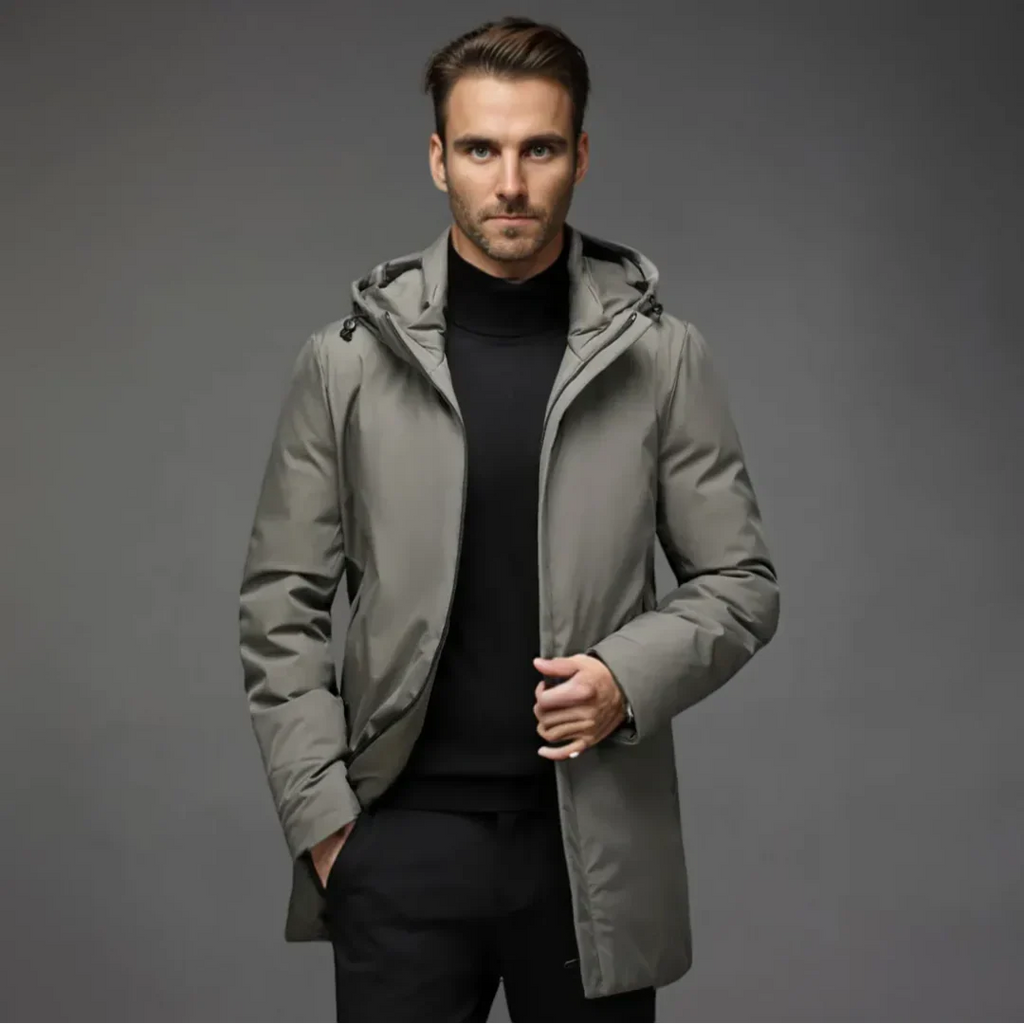 Man wearing a gray hooded jacket against a gray background