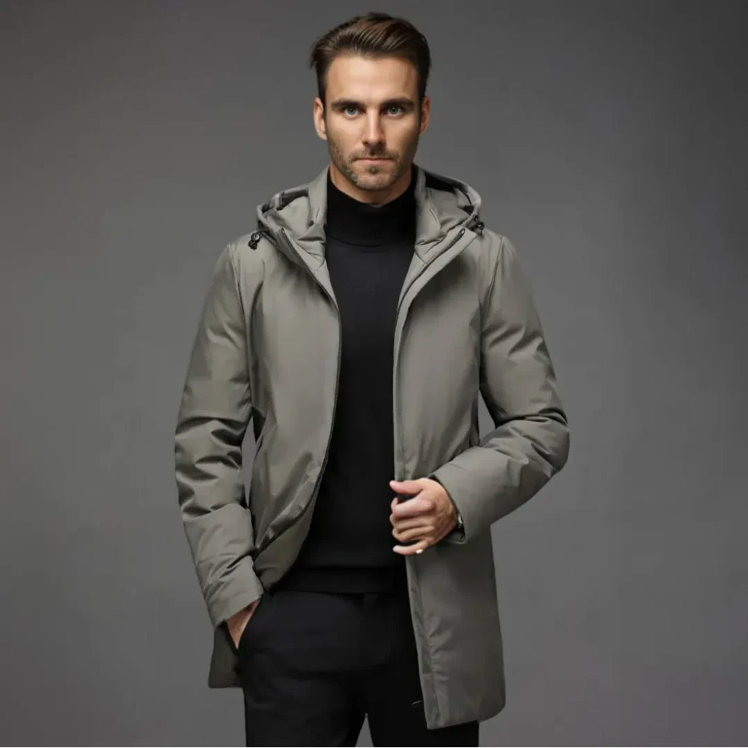 Man wearing a gray hooded jacket against a gray background
