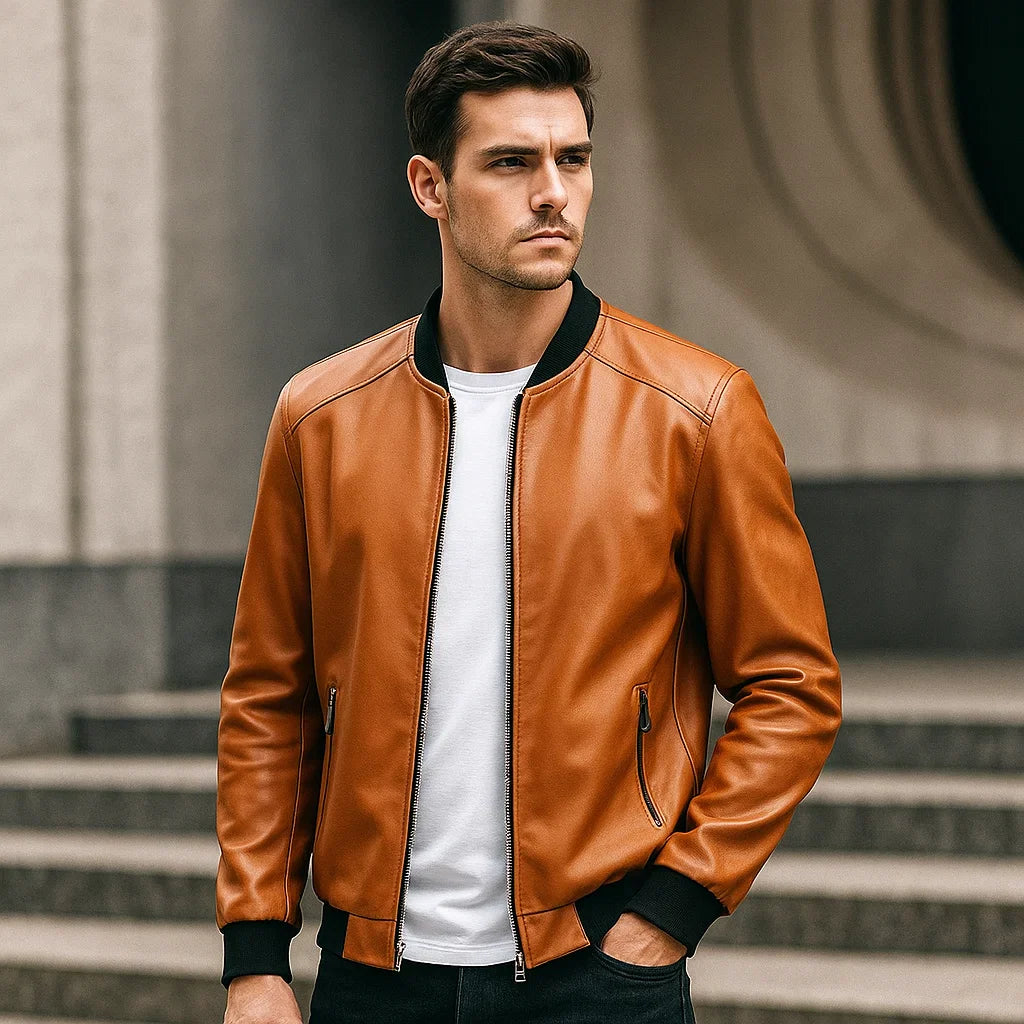 Man wearing a brown leather jacket standing outdoors.