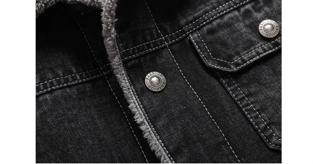 Close-up of a black denim jacket with button details on a white background