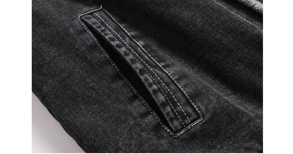 Close-up of a black denim pocket on a garment.