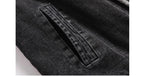 Close-up of a black denim pocket on a garment.