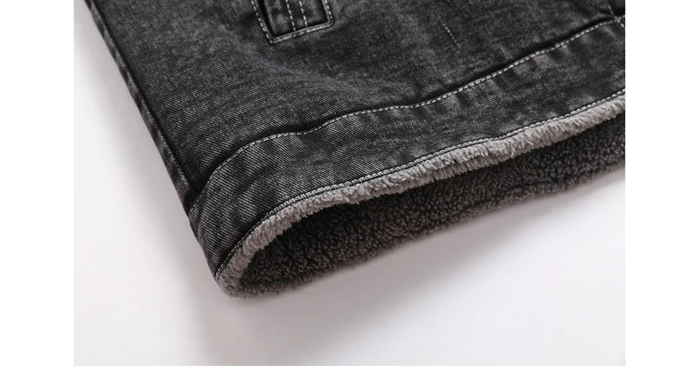 Close-up of a gray denim jacket with fleece lining on a white background