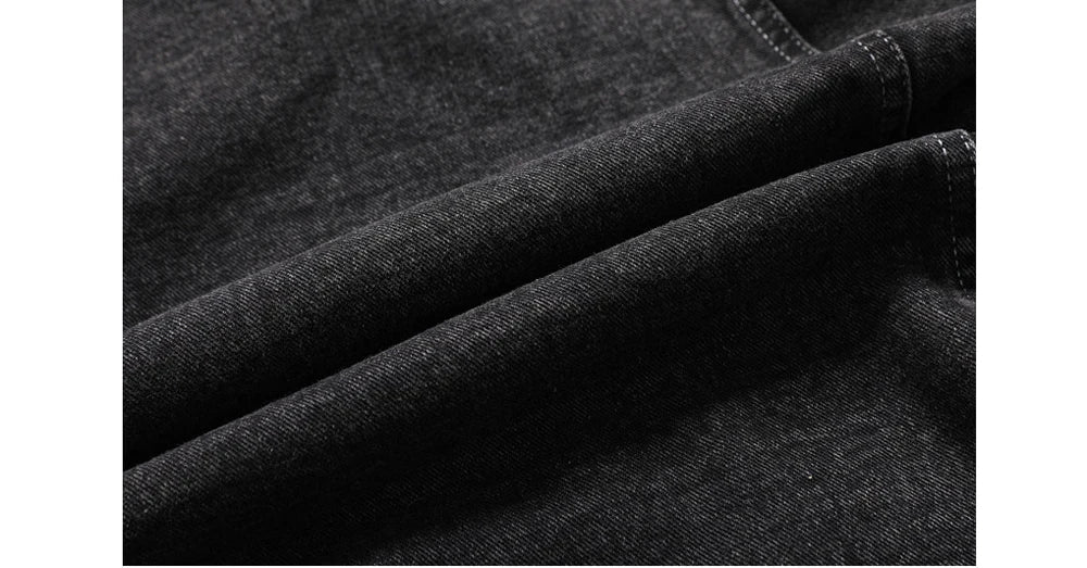 Close-up of dark denim fabric with visible texture