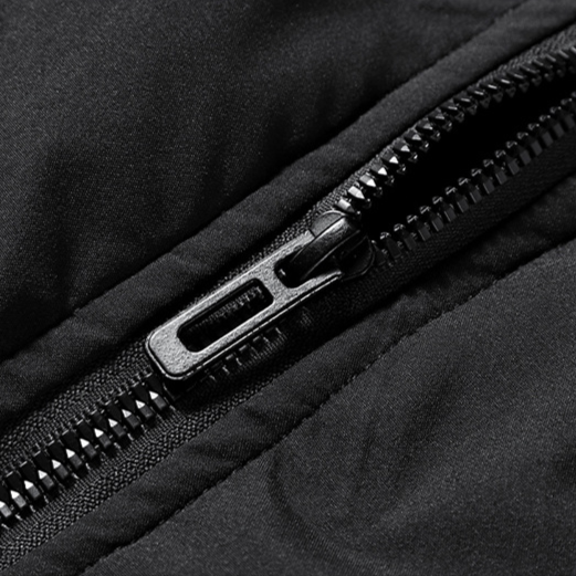 Close-up of a black zipper on a black fabric background