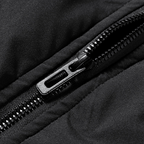 Close-up of a black zipper on a black fabric background