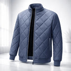 Blue quilted jacket on a white background