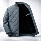 Gray quilted jacket with black fur lining on a white background