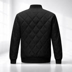 Black quilted jacket on a white background