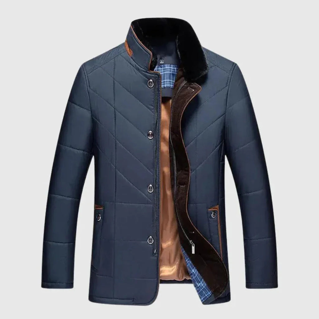 Blue quilted jacket with plaid lining on a light gray background