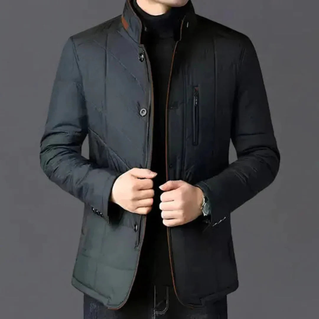 Dark gray quilted jacket with brown accents on a gray background