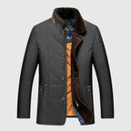 Gray quilted jacket with brown lining on a light gray background