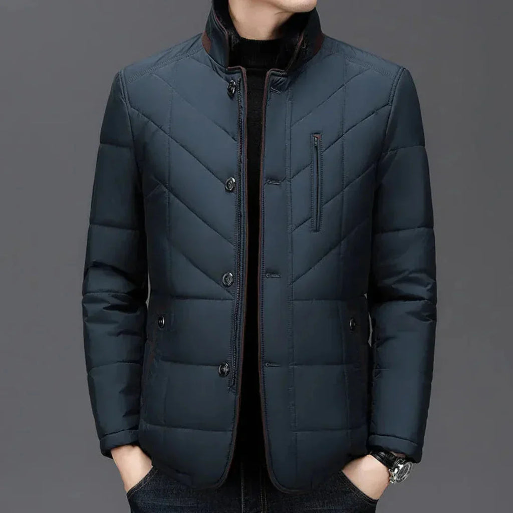 Dark blue quilted jacket on a gray background