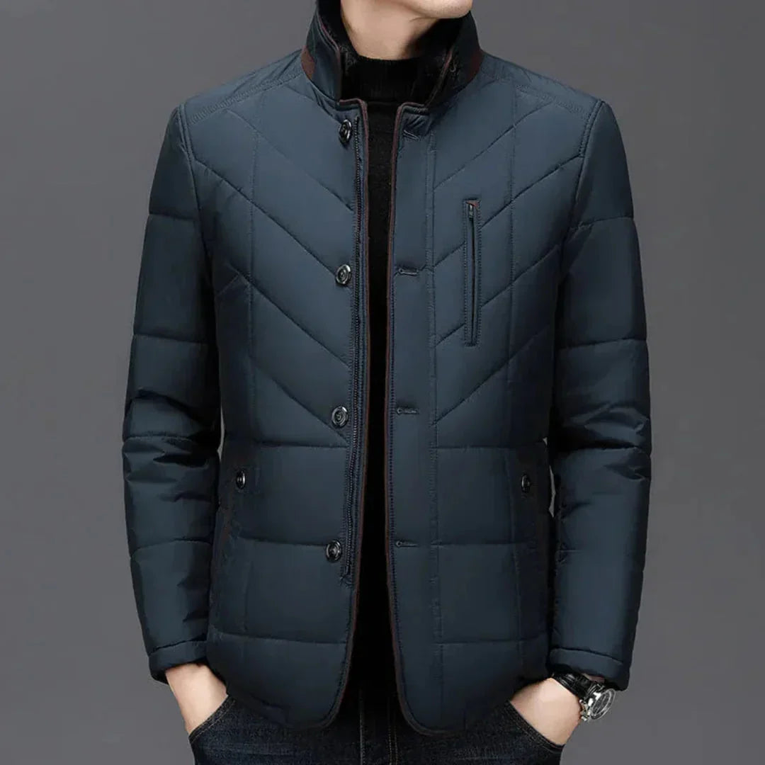 Dark blue quilted jacket on a gray background