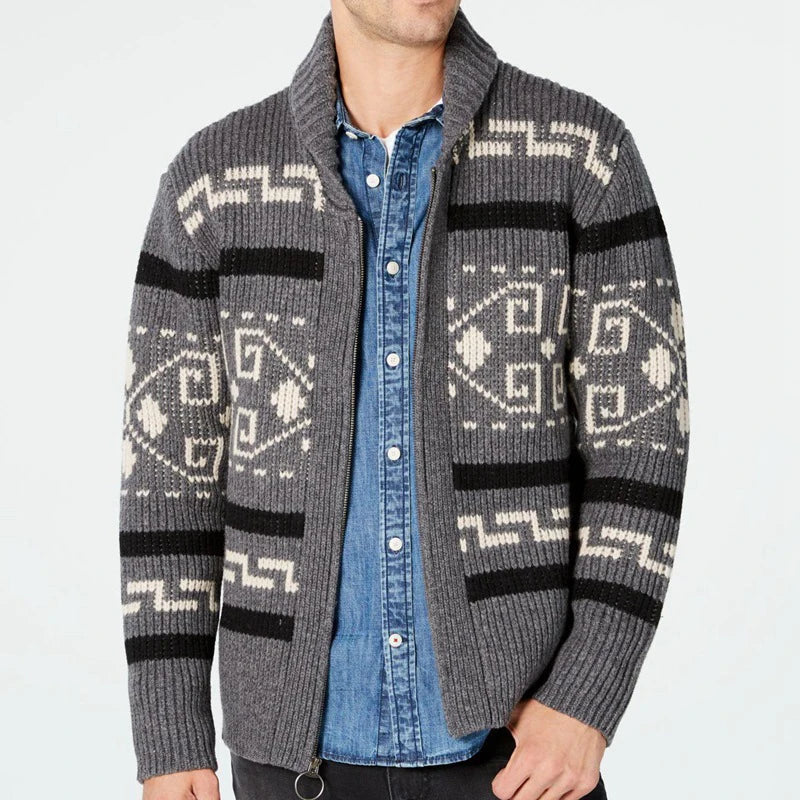 Person wearing a gray patterned cardigan over a blue shirt on a white background