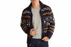 Man wearing a patterned cardigan over a gray shirt on a white background