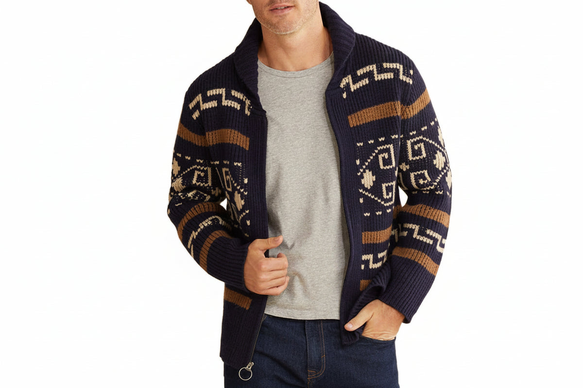 Man wearing a patterned cardigan over a gray shirt on a white background