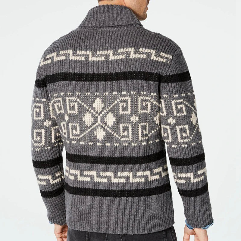 Gray sweater with a pattern on the back against a light gray background
