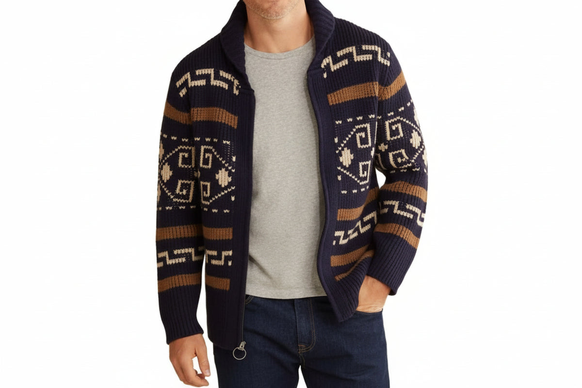 Man wearing a patterned navy sweater over a gray shirt on a white background