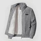Gray corduroy jacket with a white shirt underneath on a light gray background