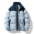 Light blue puffer jacket with navy accents on a white background