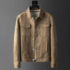 Brown suede jacket on a hanger against a gray background
