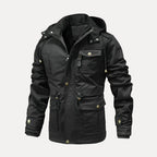 Black jacket with multiple pockets and buttons on a white background