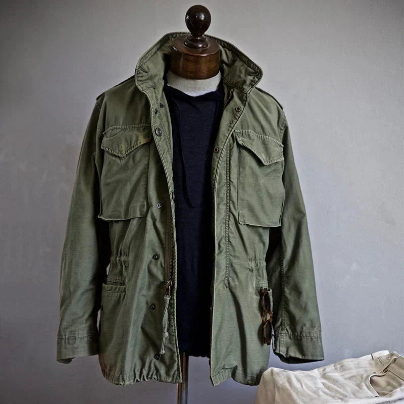 Green jacket on a mannequin against a plain background