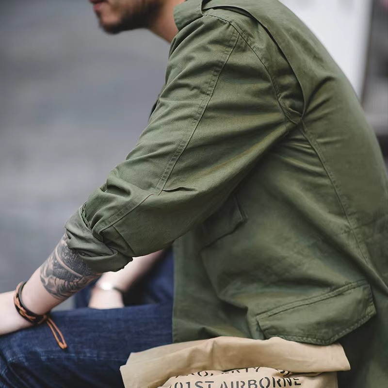Person wearing a green jacket with a blurred background
