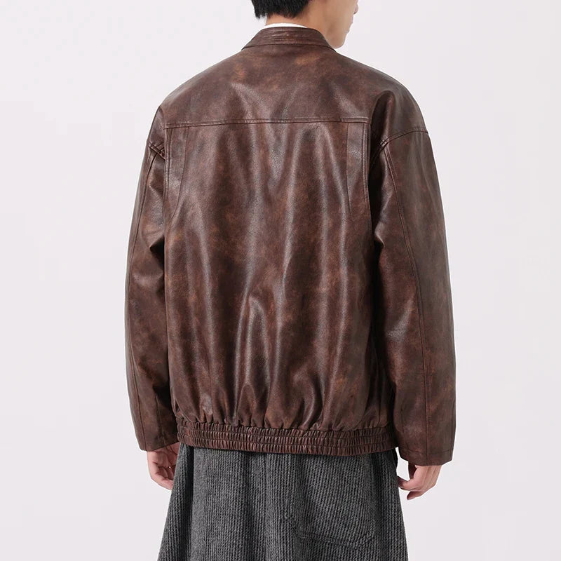 Brown leather jacket worn by a person on a white background