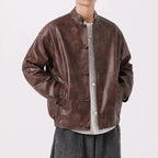 Brown leather jacket worn by a person on a white background