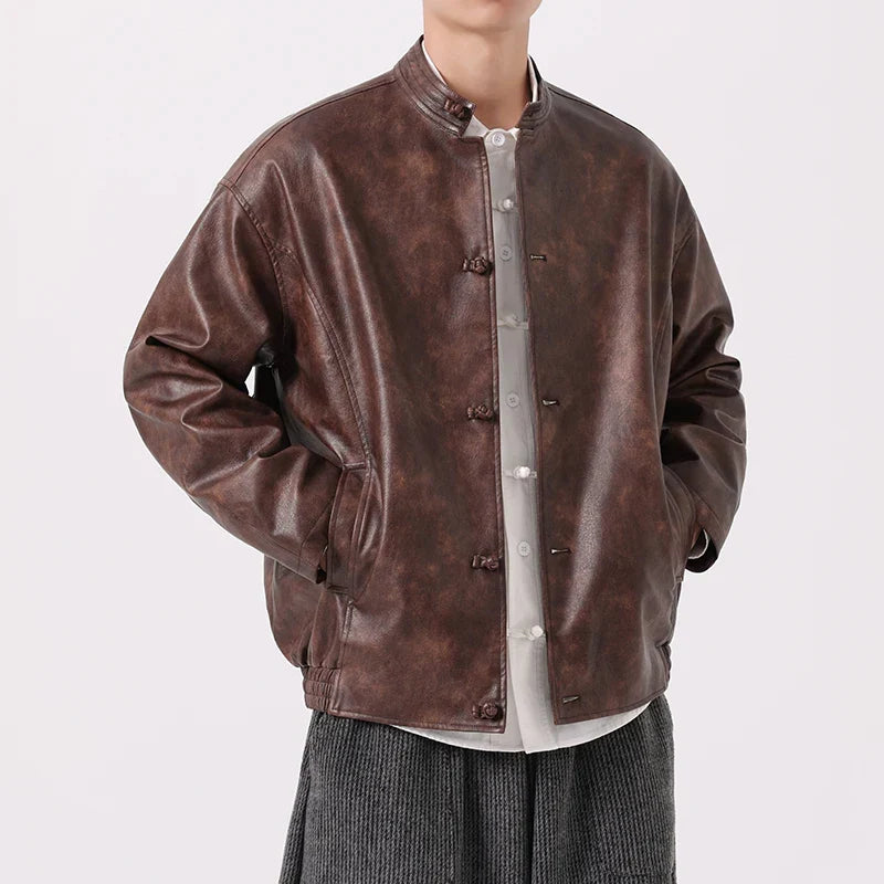 Brown leather jacket worn by a person on a white background