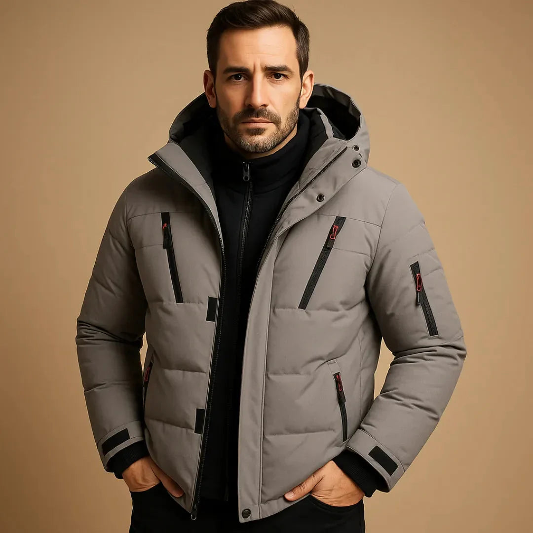 Man wearing a gray puffer jacket on a beige background
