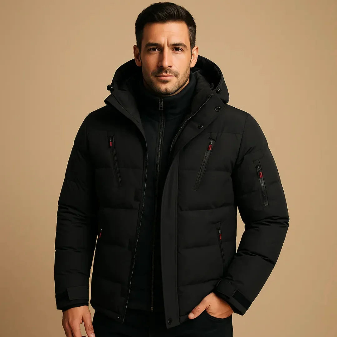 Man wearing a black puffer jacket on a beige background