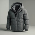 A dark gray hooded puffer jacket with a soft fleece-lined hood, shown on a neutral gray background.