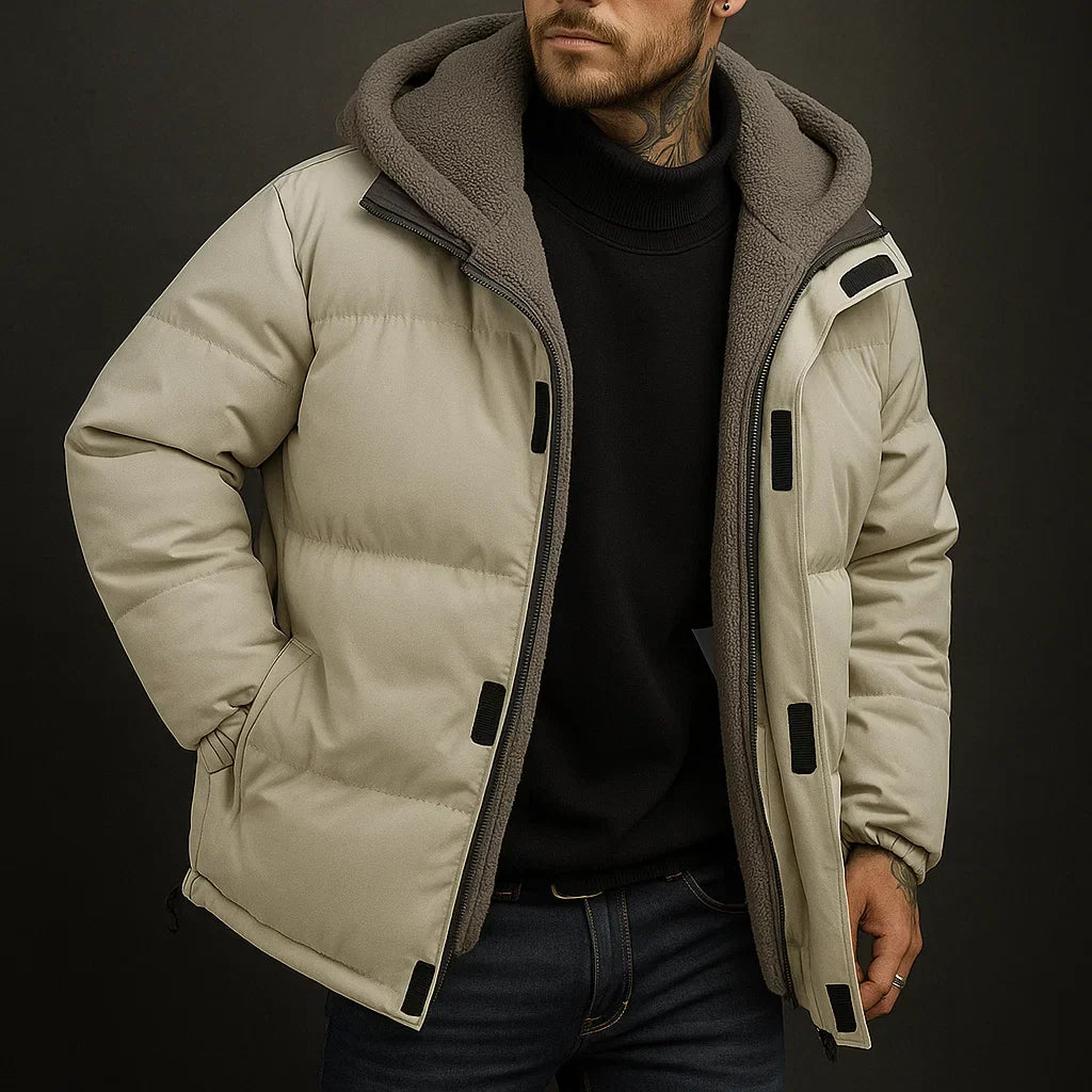 Man wearing a beige puffer jacket with a dark background