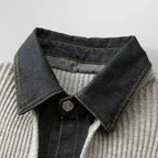 Close-up of a denim collar on a gray sweater with a white background