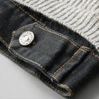 Close-up of a button on a denim jacket with a gray background